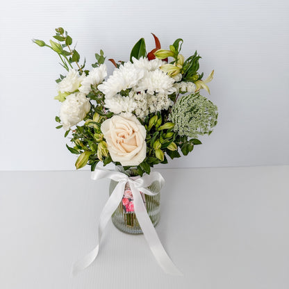 Bouquet of white and light-coloured flowers in a clear glass ribbed vase with a white ribbon |  Sympathy Bunch in Glass Vase Small size | Bliss and Bloom Studio | Perth Flower Delivery