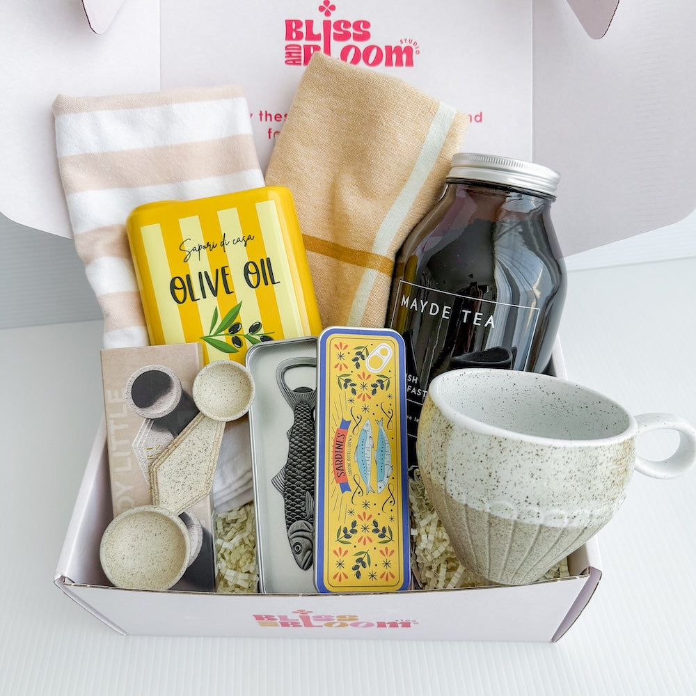 Gift box containing an 'Olive Oil Tin' Ceramic Vase, a 'Sardine' bottle opener, 2 pieces tea towels, a ceramic mug, loose leaf tea, and a ceramic double spoon | Perth Gift Delivery
