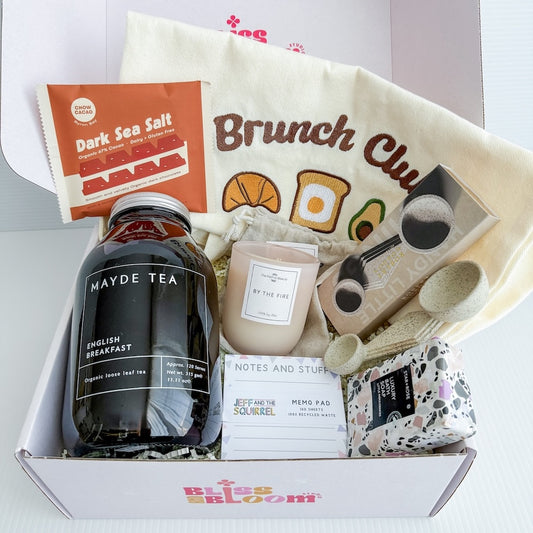 Gift box with 'Brunch Club' tote bag, Mayde Tea loose leaf tea, ceramic double spoon, soy wax candle, memo pad, a chocolate slab, and a body bar | Perth Delivery